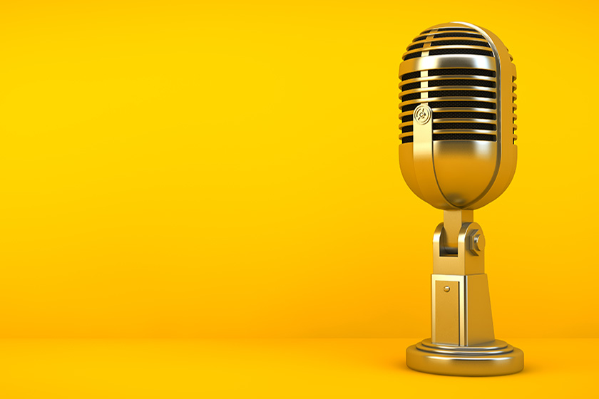 gold microphone on yellow background